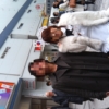 秋葉原駅前で記念撮影する大学生とメイド